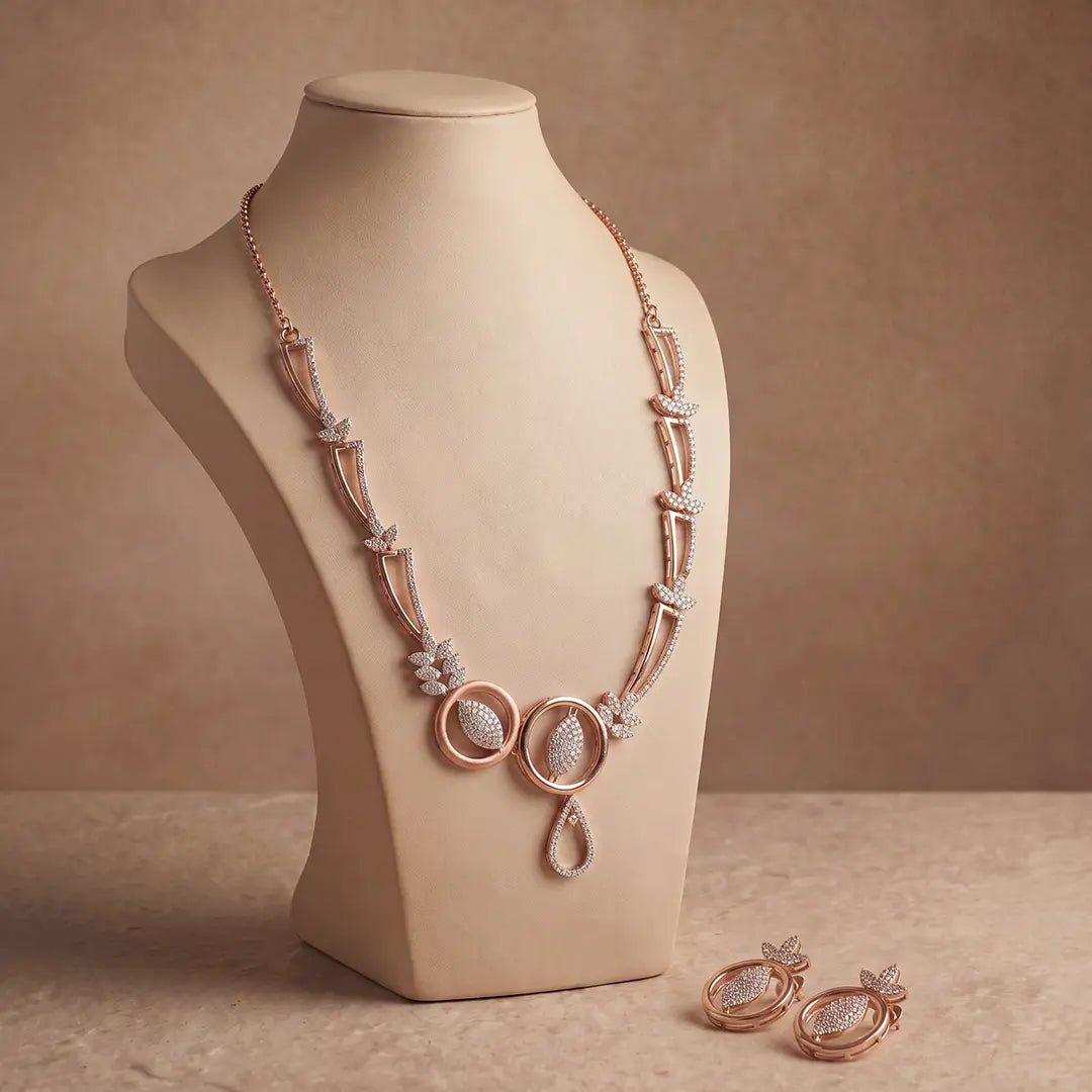 925 sterling silver rose gold-toned necklace and earrings set with circular motifs, white stone leaf detailing and teardrop design by Parijat Jewels for wholesale jewellery retailers